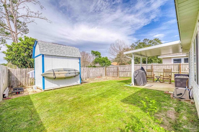 view of yard with a storage shed, a patio, an outdoor structure, and a fenced backyard