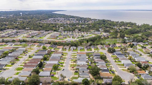 birds eye view of property with a water view and a residential view