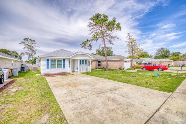 single story home with a garage, concrete driveway, a porch, and a front lawn