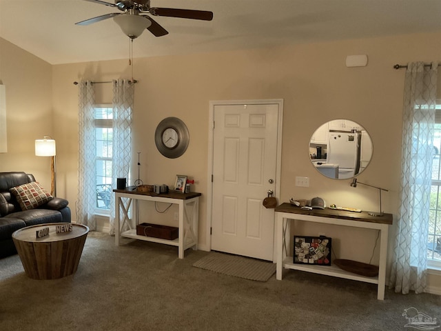 living area with carpet floors and a ceiling fan