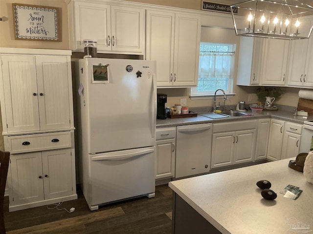 kitchen with white appliances, dark wood-type flooring, white cabinets, and a sink