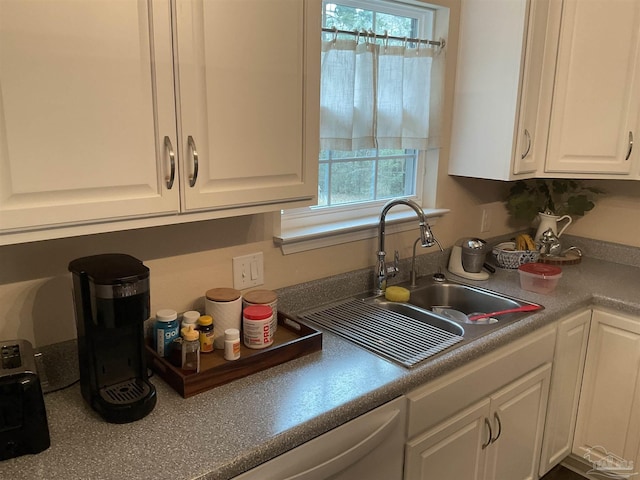 kitchen with a sink and white cabinetry