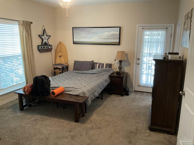 bedroom featuring baseboards and light colored carpet