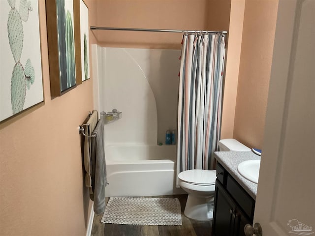 full bathroom featuring wood finished floors, shower / bath combo with shower curtain, vanity, and toilet