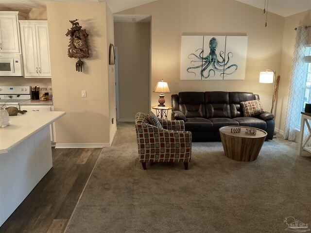 living room featuring vaulted ceiling, dark carpet, dark wood finished floors, and baseboards