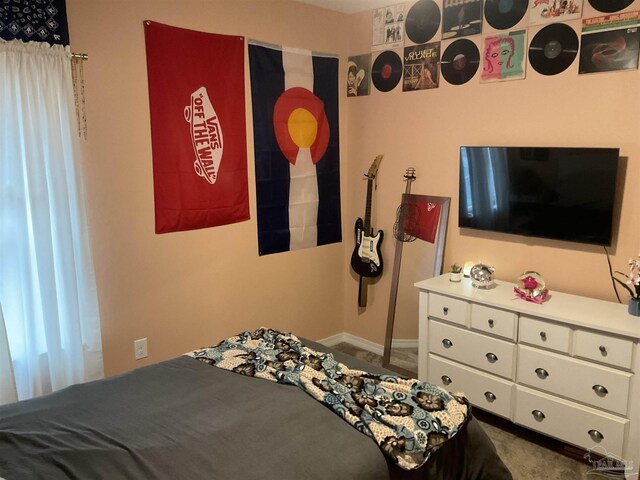 bedroom featuring dark colored carpet