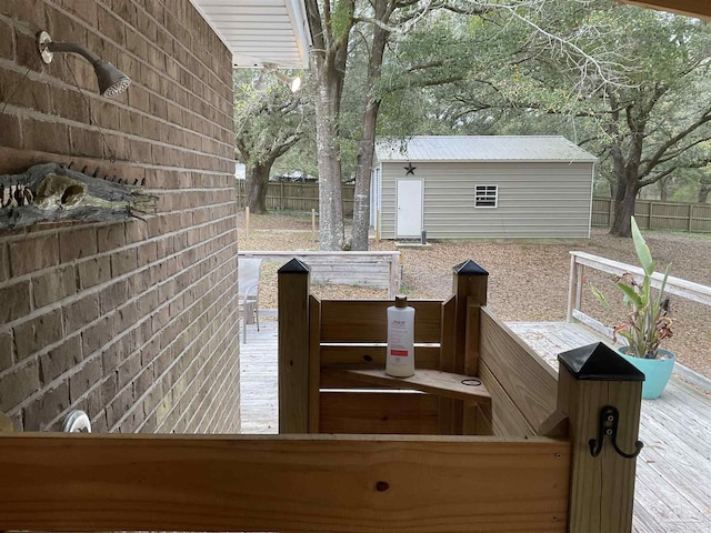 wooden deck with fence and an outbuilding