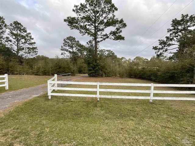 view of gate featuring a yard and fence