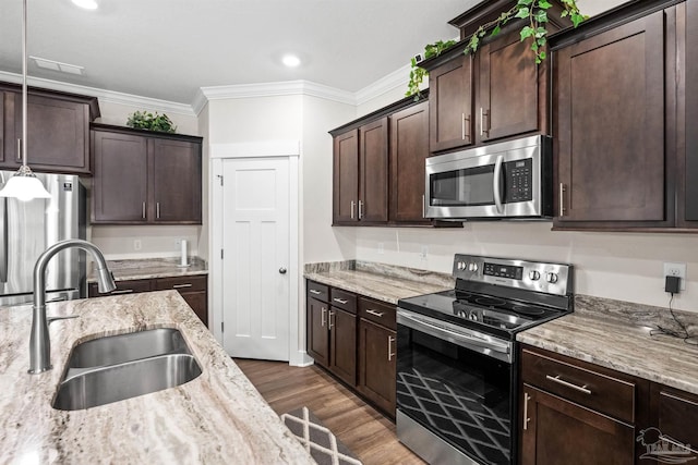 kitchen with stainless steel appliances, dark wood-style flooring, crown molding, and a sink