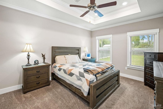 bedroom featuring carpet floors, ornamental molding, a raised ceiling, and baseboards