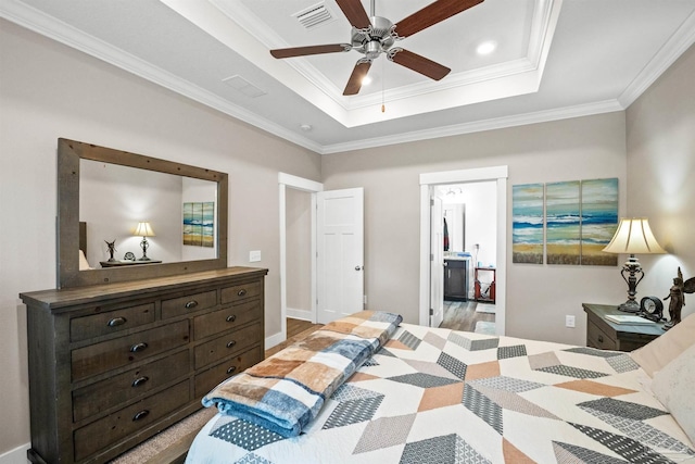 bedroom featuring a tray ceiling, crown molding, recessed lighting, visible vents, and ceiling fan