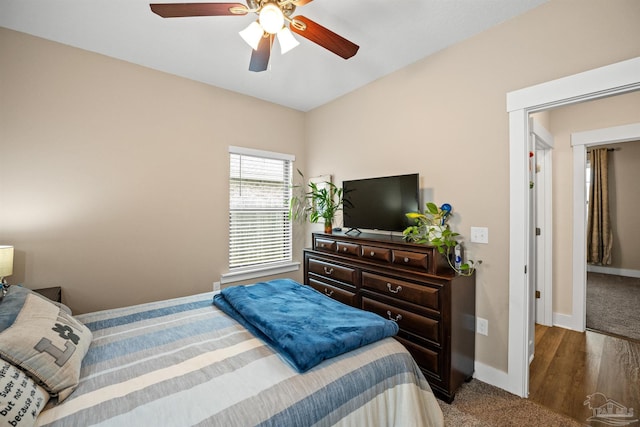 bedroom with ceiling fan and baseboards