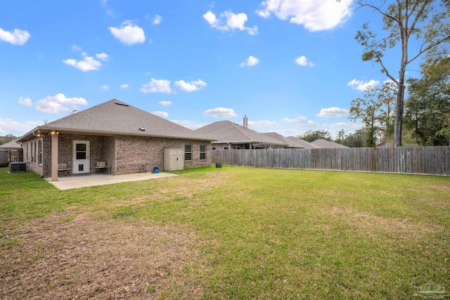 view of yard with a patio area, a fenced backyard, and central AC unit