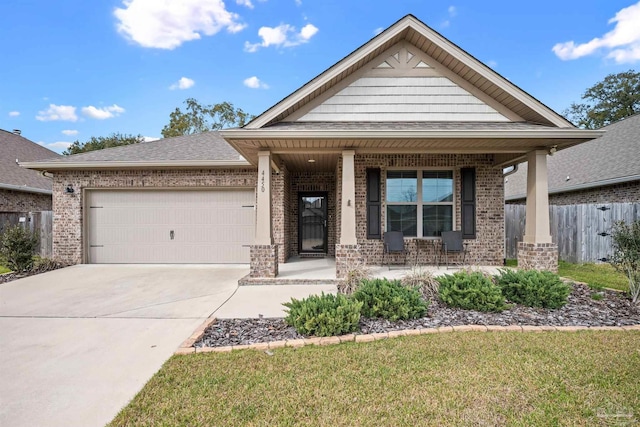 view of front of home with brick siding, a porch, a shingled roof, a garage, and driveway