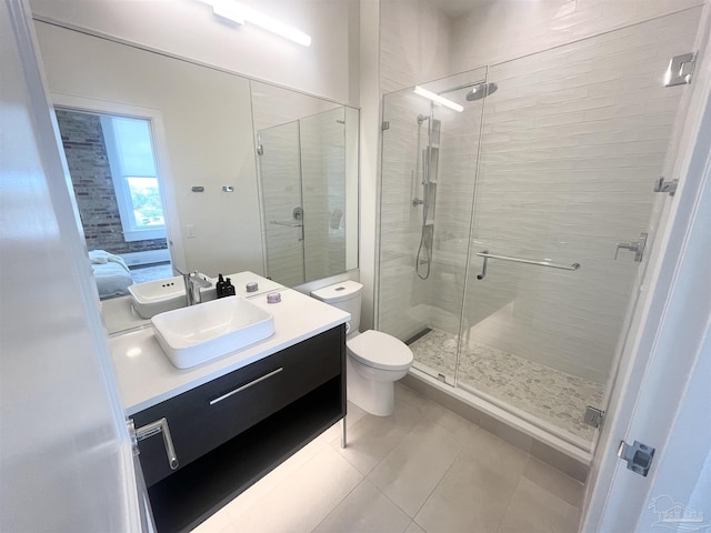 bathroom featuring a stall shower, tile patterned flooring, and vanity