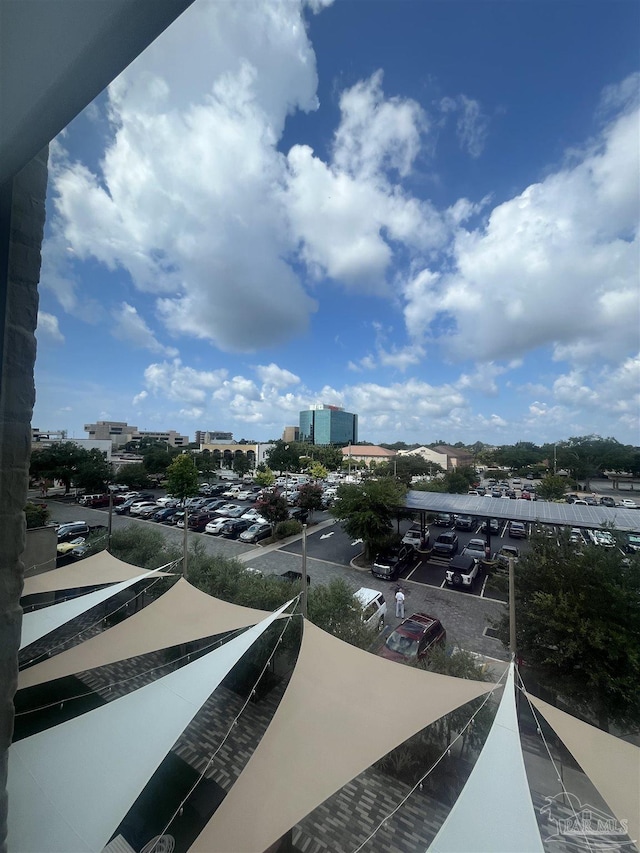 exterior space with uncovered parking and a city view