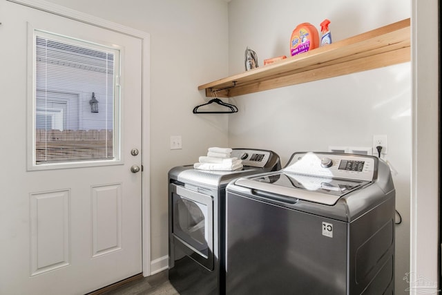 laundry area featuring washer and clothes dryer and dark hardwood / wood-style floors