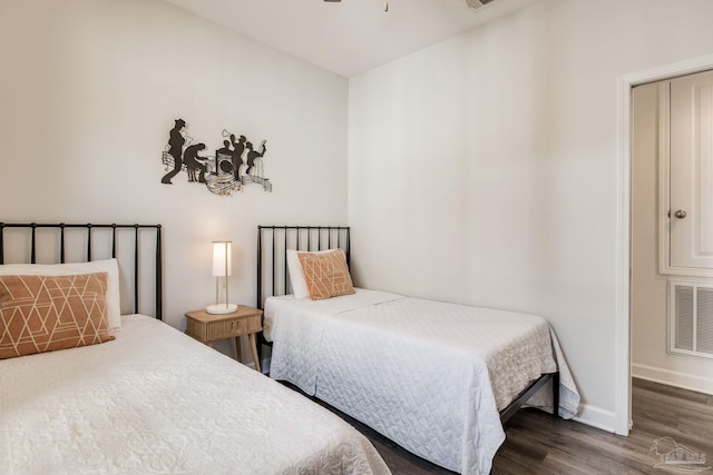 bedroom with dark hardwood / wood-style flooring