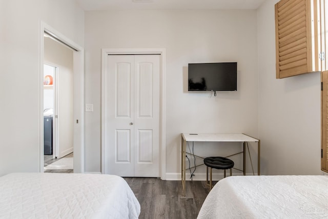 bedroom featuring dark hardwood / wood-style flooring and a closet