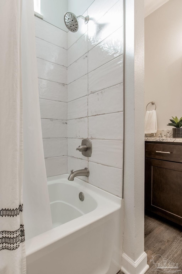 bathroom featuring hardwood / wood-style flooring and shower / bathtub combination with curtain