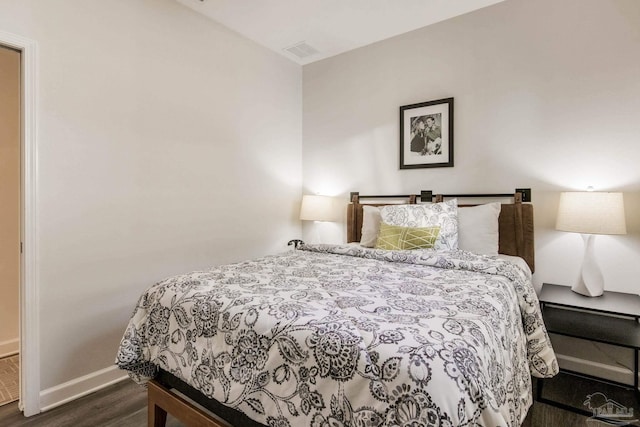 bedroom featuring dark hardwood / wood-style flooring