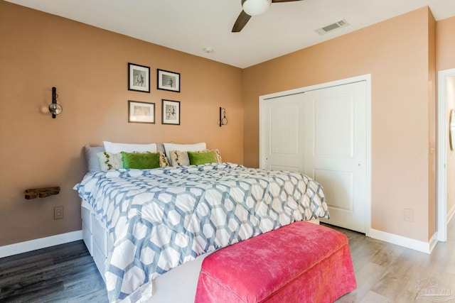 bedroom with hardwood / wood-style floors, a closet, and ceiling fan