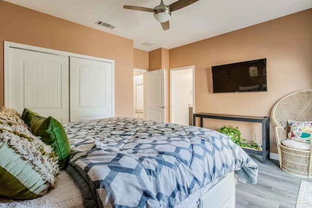 bedroom featuring ceiling fan, a closet, and light hardwood / wood-style floors