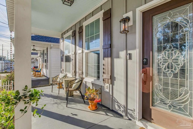 view of exterior entry featuring covered porch