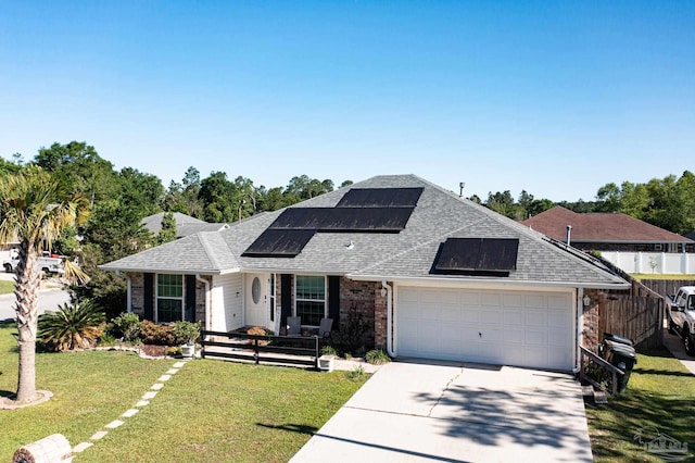 view of front of home with roof with shingles, covered porch, a garage, driveway, and a front lawn