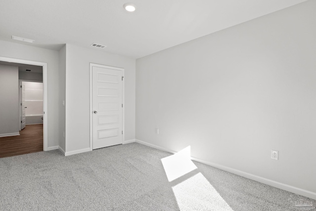 unfurnished bedroom with carpet flooring, baseboards, and visible vents