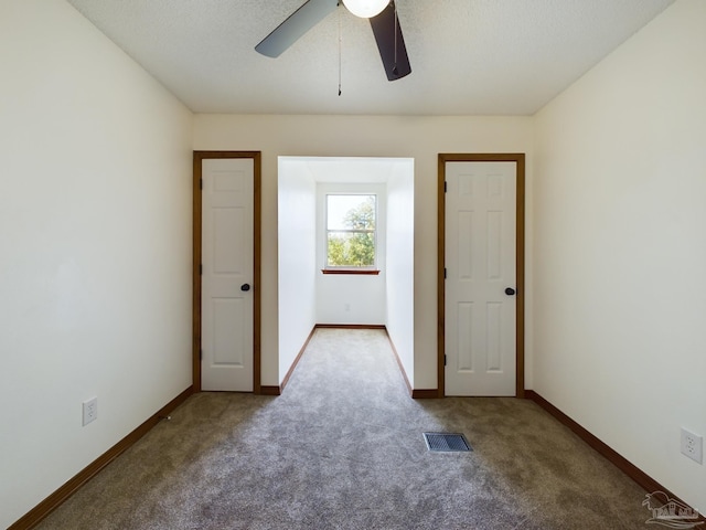 carpeted empty room with ceiling fan