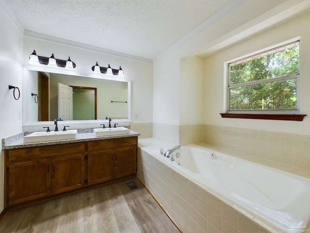 bathroom with crown molding, wood-type flooring, a textured ceiling, and vanity