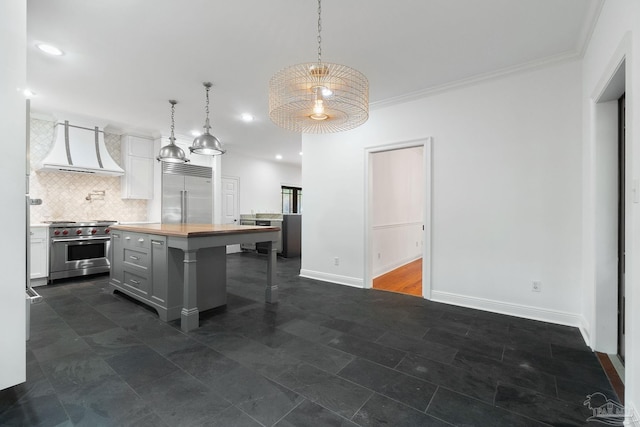 kitchen with wooden counters, backsplash, high quality appliances, custom exhaust hood, and a breakfast bar