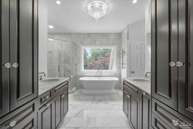 full bath with two vanities, a sink, and marble finish floor