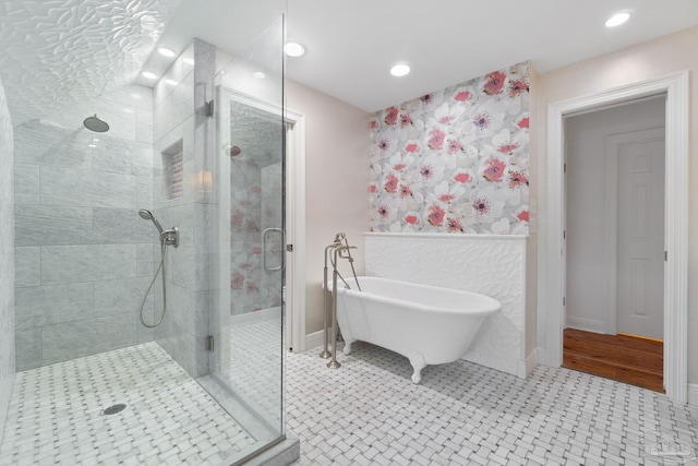 full bath with recessed lighting, a freestanding tub, baseboards, and a shower stall