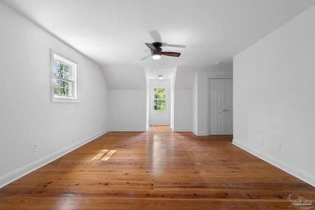 bonus room featuring wood-type flooring, ceiling fan, and baseboards