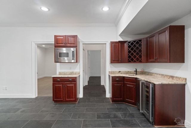 kitchen with beverage cooler, stainless steel microwave, ornamental molding, and reddish brown cabinets