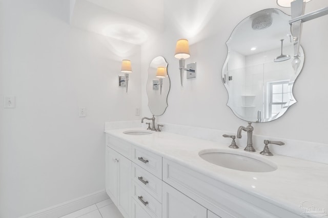 bathroom with a sink, tile patterned floors, a shower, and double vanity