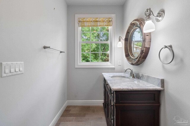 bathroom with baseboards and vanity