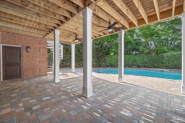 view of patio with a fenced in pool and a ceiling fan