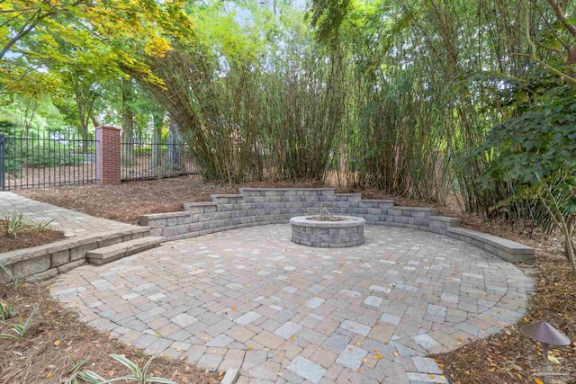 view of patio / terrace with fence and an outdoor fire pit