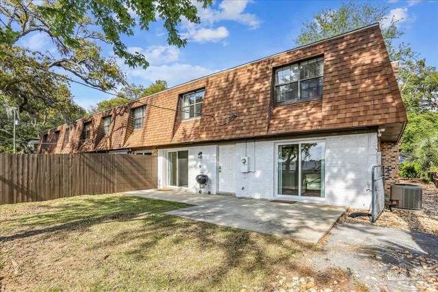 2707 E De Soto St, Pensacola, FL 32503 - rear view of property with fence, a patio area, brick siding, central AC unit, and a shingled roof