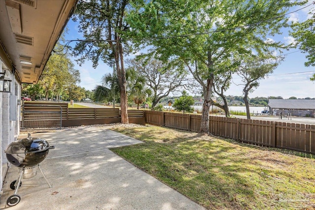 2707 E De Soto St, Pensacola, FL 32503 - view of yard with a water view, a patio area, and a fenced backyard