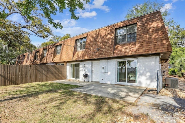 2707 E De Soto St, Pensacola, FL 32503 - rear view of property with fence, a patio area, brick siding, central AC unit, and a shingled roof