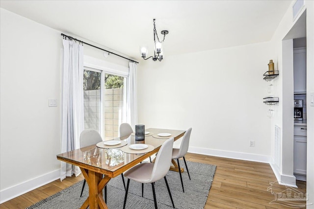 2707 E De Soto St, Pensacola, FL 32503 - dining space with an inviting chandelier, visible vents, baseboards, and light wood-style flooring