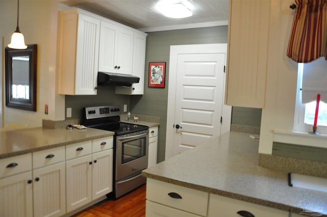 4565 Forsyth St, Bagdad, FL 32583 - kitchen with stainless steel electric stove, under cabinet range hood, white cabinets, hanging light fixtures, and light countertops