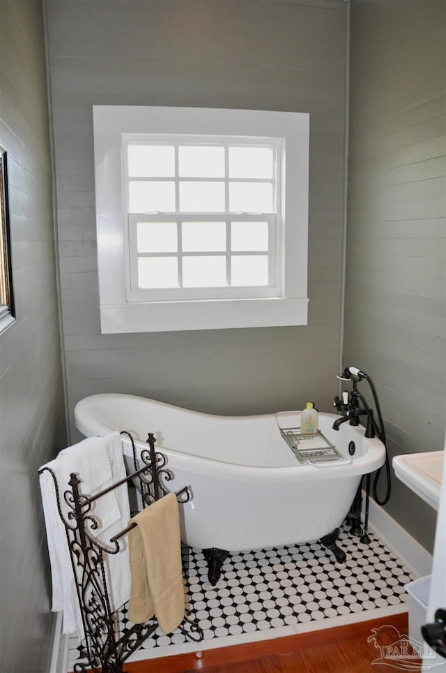4565 Forsyth St, Bagdad, FL 32583 - bathroom featuring plenty of natural light, a freestanding bath, and baseboards