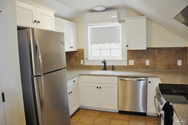 4565 Forsyth St, Bagdad, FL 32583 - kitchen with appliances with stainless steel finishes, a sink, a wall mounted AC, lofted ceiling, and white cabinets