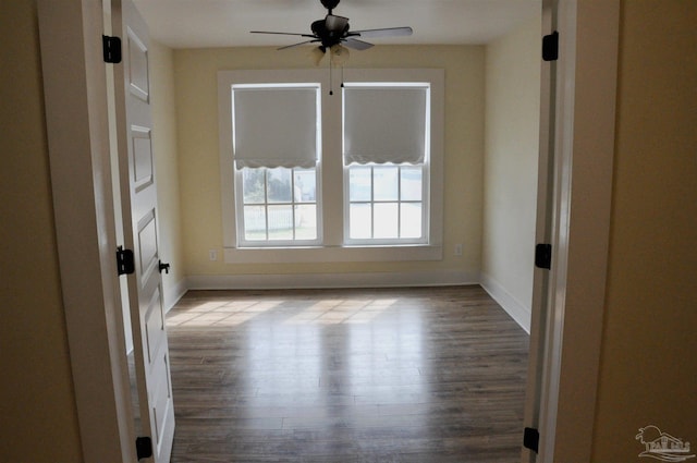 4565 Forsyth St, Bagdad, FL 32583 - empty room featuring wood finished floors, baseboards, and a ceiling fan
