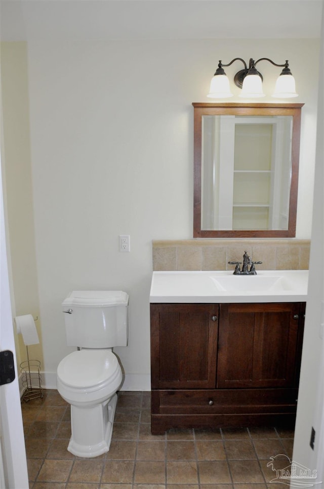 4565 Forsyth St, Bagdad, FL 32583 - bathroom featuring vanity, toilet, baseboards, and decorative backsplash